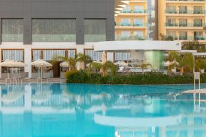 a large swimming pool in front of a building at NissiBlu Beach Resort in Ayia Napa