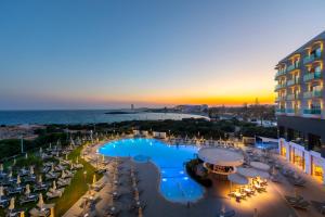 a view of a resort with a pool and the ocean at NissiBlu Beach Resort in Ayia Napa