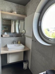 baño con lavabo y ventana en Monopol Apartments, en Wernigerode