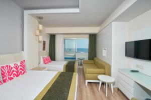 a living room with a couch and a television at Orange County Alanya in Okurcalar +165 photos