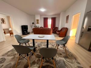 a living room with a table and two chairs at Kino Apartment in Tirana