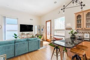 a living room with a blue couch and a table at Ocean View Hot Tub Luxe House Steps to Sand in Hermosa Beach +55 photos