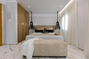 a bedroom with a large bed and a large window at Olvos Suite in Naxos Chora