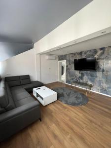 a living room with a couch and a tv at Villa Luca in Sarajevo