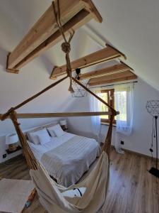 a bedroom with a bed and a hammock at Leszczynowe Zacisze in Wiele