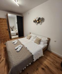 a bedroom with a large bed with towels on it at Apartman Lidija in Starigrad +42 photos