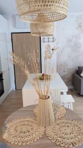 a table with a vase with flowers in a room at Apartament&SPA Lis&Las in Sobótka +9 photos