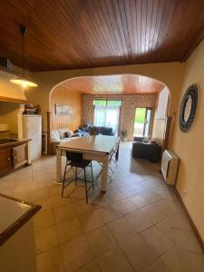 a kitchen and living room with a table in it at Maison entière billard , video proj 125 m2 in Beaumont