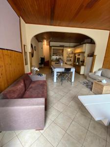 a living room with a couch and a table at Maison entière billard , video proj 125 m2 in Beaumont