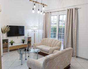 a living room with two chairs and a tv at Nikolias dream house in Ialysos