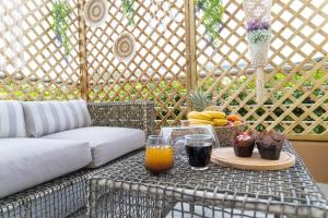 a table with a tray of fruit and drinks on a patio at Nikolias dream house in Ialysos