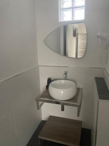 a bathroom with a sink and a mirror at AL MAR 38 in Brindisi