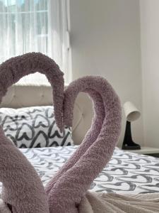 a pair of towels forming a heart on a bed at Starlux apartment in Mostar