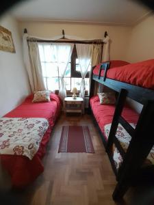 a bedroom with two bunk beds and a window at Pampa in San Carlos de Bariloche