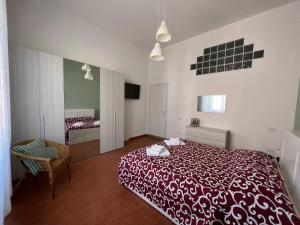 a bedroom with a red bed in a room at speZialhouse - Centro Storico & Cinque Terre in La Spezia
