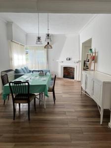 un soggiorno con tavolo e sedie verdi di Casa tipo chalet en PH a tres cuadras del mar a Mar del Plata