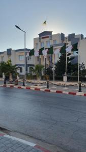 a street with flags in front of a building at Villa 250 m2 terrasse plus Garage in Mostaganem