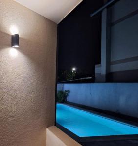 a view of a swimming pool in a house at night at House Reko in Novi Grad