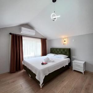 a bedroom with a large bed and a window at Newsuit2023 in Trabzon