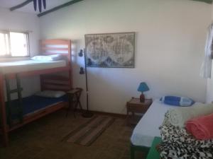 a bedroom with two bunk beds and a window at Los Aventureros in Samaipata