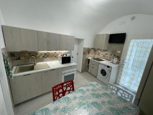 a kitchen with a table and a sink and a stove at Sea Paradise in Gallipoli