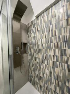 a bathroom with a shower and a tile wall at Sea Paradise in Gallipoli +11 photos