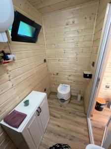 a small bathroom with a toilet and a sink at Tiny House HaleLuJa 