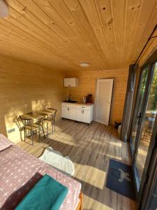 a room with a bed and a table in a cabin at Tiny House HaleLuJa 
