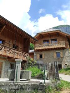 a building with a balcony on the side of it at L'échappée Belle en Montagne in Mieussy