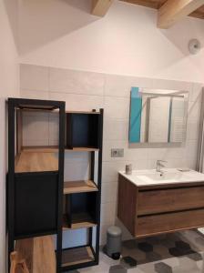 a bathroom with a sink and a mirror at L'échappée Belle en Montagne in Mieussy