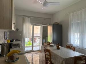 a kitchen with a table with chairs and a counter top at Kiki's house Afytos in Afitos