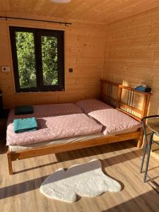 a bedroom with two beds in a wooden cabin at Tiny House HaleLuJa 