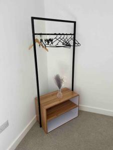 a room with a shelf with a bird on it at New Build 2 Bedroom Luxury Apartment, Jewellery Quarter Birmingham in Birmingham
