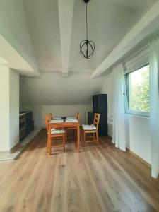 a dining room with a table and two chairs at Apartment Savkovic in Šipovo