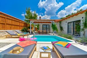 a backyard with a swimming pool and two beds at Sojoy Villa Allure in Fethiye
