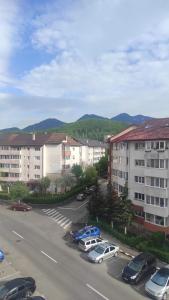 a parking lot with cars parked in front of buildings at Noua Apartment in Braşov