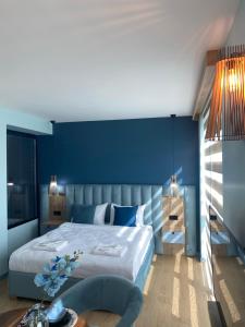 a bedroom with a large bed with a blue wall at Honeymoon No16 with Big hot tube in Istanbul