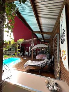 a living room with a hammock and a swimming pool at Ti Koin Trankil Belle & spacieuse villa tropicale in Saint-Pierre