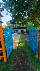 a row of blue fences in front of a building at Casa hostal playa coral in Capurganá