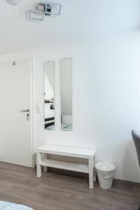a white room with a bench and a mirror at modern house with pool - 3 bedrooms 2 Bathrooms in Memmingen
