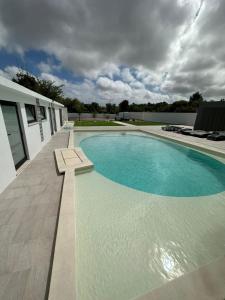 a large swimming pool next to a white building at 145 Townhouse in Ílhavo +50 photos