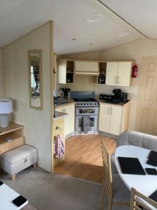 a small kitchen and dining room with a table at Ingoldmells, Coral beach, 8 birth in Ingoldmells