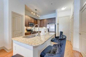 a kitchen with a counter with a sink and a chair at Houston Texas 1BR APT With pool view near NRG and MED CENTER in Houston