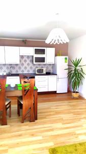 a kitchen with white cabinets and a table and chairs at Widok na Śnieżkę in Miłków