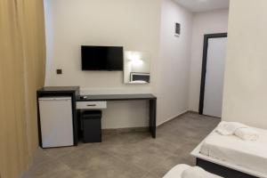 a room with a desk and a tv on the wall at Pera Side Hotel in Side