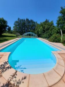 una piscina de agua azul claro en Maison de Vacances Tissendie, en Bourg-de-Visa