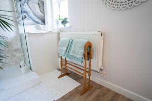 a towel rack in a bathroom with a window at Driftwood by the Sea in Brighton & Hove