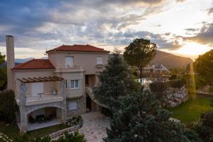 an aerial view of a house with the sunset in the background at Villa San Adriano in Nafplio