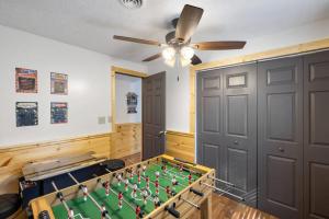 a room with a pool table and a ceiling fan at Secret Hideout in Sevierville