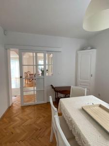 a room with a table and chairs and a dining room at Downtown House with garden in Sarajevo